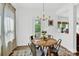 Cozy dining area with a round table, modern chandelier, and natural light from the backyard at 3153 Pinehills Way, Mount Holly, NC 28120