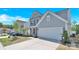 Inviting two-story home with a well-manicured lawn and attached two-car garage at 3153 Pinehills Way, Mount Holly, NC 28120