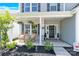 Cozy front porch featuring rocking chairs and decorative plants at 3153 Pinehills Way, Mount Holly, NC 28120