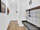 Hallway leading to rooms with dark gray bench and shoe storage at 3153 Pinehills Way, Mount Holly, NC 28120