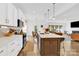 Modern kitchen with white cabinets, stainless steel appliances, and an island with seating at 3153 Pinehills Way, Mount Holly, NC 28120