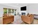 Bright living room featuring a fireplace, large windows, and comfortable armchairs at 3153 Pinehills Way, Mount Holly, NC 28120