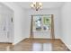 Open living area with light-colored wood flooring and a large window that brings in natural light at 3153 Pinehills Way, Mount Holly, NC 28120