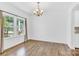 Spacious living room with light colored wood floors and large windows for natural light at 3153 Pinehills Way, Mount Holly, NC 28120