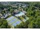 Aerial view of community pool, water park, tennis and basketball courts surrounded by lush landscaping at 3306 Delamere Dr, Matthews, NC 28104