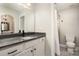 Bright bathroom featuring gray countertop, white cabinets, and toilet with shower area at 3306 Delamere Dr, Matthews, NC 28104