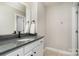 Bathroom with a gray countertop, white cabinets, undermount sink, and brushed bronze faucet at 3306 Delamere Dr, Matthews, NC 28104
