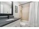 Updated bathroom with a shower-tub combo and modern finishes at 3306 Delamere Dr, Matthews, NC 28104