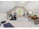 Bonus room or flex space with vaulted ceilings, natural light, and built-in bookshelves at 3306 Delamere Dr, Matthews, NC 28104