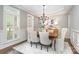 Formal dining room with chandelier, wainscoting, and plenty of natural light from the window at 3306 Delamere Dr, Matthews, NC 28104