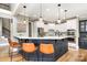 Well-lit kitchen with marble countertops, a breakfast bar, and modern stainless steel appliances at 3306 Delamere Dr, Matthews, NC 28104