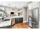Spacious kitchen with a stainless steel refrigerator, marble countertop, and hardwood floors at 3306 Delamere Dr, Matthews, NC 28104