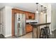 Charming kitchenette with wooden cabinets, stainless steel refrigerator, and bar-style seating at 3306 Delamere Dr, Matthews, NC 28104