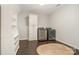 Spacious laundry room featuring wooden floors, shelving, and modern washer and dryer units at 3306 Delamere Dr, Matthews, NC 28104