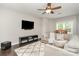 Cozy living room with a large sectional sofa, mounted TV, and elegant area rug at 3306 Delamere Dr, Matthews, NC 28104