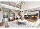 Spacious living room with wrought iron staircase, kitchen view, hardwood floors, and stylish decor at 3306 Delamere Dr, Matthews, NC 28104