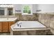 A spa-like bathroom with a large soaking tub surrounded by elegant tiling at 3546 Mount Pleasant N Rd, Concord, NC 28025
