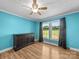 Bedroom with blue walls, wood-look flooring, and dresser at 3546 Mount Pleasant N Rd, Concord, NC 28025