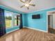 Bedroom featuring hardwood floors, two windows for ample natural light, and a ceiling fan at 3546 Mount Pleasant N Rd, Concord, NC 28025