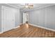 A standard bedroom with grey walls, light-colored flooring, and white trim at 3546 Mount Pleasant N Rd, Concord, NC 28025