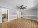 Spacious bedroom with wood floors, natural light from windows, and modern ceiling fan at 3546 Mount Pleasant N Rd, Concord, NC 28025