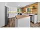 Modern kitchen boasts white cabinets, stainless steel appliances, butcher block island, and unique wall accents at 3546 Mount Pleasant N Rd, Concord, NC 28025