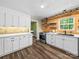 Bright kitchen featuring stainless steel appliances, modern cabinetry, wood floors, and accent wall at 3546 Mount Pleasant N Rd, Concord, NC 28025