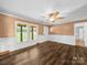 Inviting living room features beautiful wood floors, wainscotting, and natural light from the large windows at 3546 Mount Pleasant N Rd, Concord, NC 28025
