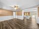Inviting living room features beautiful wood floors, wainscotting, and open access to the kitchen at 3546 Mount Pleasant N Rd, Concord, NC 28025