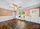 Inviting living room features beautiful wood floors, wainscotting, and natural light from the large windows at 3546 Mount Pleasant N Rd, Concord, NC 28025