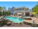 Beautiful backyard with a sparkling pool, hot tub, brick patio, and lush landscaping, perfect for outdoor entertaining at 4160 Isle Of Pines Dr, Denver, NC 28037