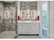Modern bathroom with double vanity, backlit mirrors, and glass shower at 4160 Isle Of Pines Dr, Denver, NC 28037
