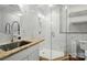 Bathroom with marble tiles, granite countertop, glass shower, and modern fixtures at 4160 Isle Of Pines Dr, Denver, NC 28037