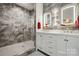 Elegant bathroom with a glass-enclosed shower, marble walls, and double vanity sinks at 4160 Isle Of Pines Dr, Denver, NC 28037