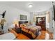 Bedroom featuring hardwood floors, desk, and decorative lamps at 4160 Isle Of Pines Dr, Denver, NC 28037