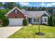 Charming single-Gathering home featuring a brick and siding facade, a well-manicured lawn, and an attached two-car garage at 4160 Isle Of Pines Dr, Denver, NC 28037