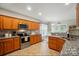 Modern kitchen with stainless steel appliances, granite countertops, and a view into the cozy breakfast nook, ideal for Gathering gatherings at 4160 Isle Of Pines Dr, Denver, NC 28037