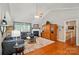 Comfortable living room featuring a vaulted ceiling, a fireplace, hardwood floors, and a serene view of the backyard at 4160 Isle Of Pines Dr, Denver, NC 28037