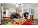 Open-concept living room with a desk area, sofa, and kitchen in background, ideal for versatile living at 4160 Isle Of Pines Dr, Denver, NC 28037