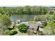Aerial view of a home nestled on a lush property by a lake, showcasing its prime location and landscape at 455 W Gleneagles Rd, Statesville, NC 28625