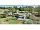 Stunning aerial view of a traditional-style home with a private pool and lush green landscaping on a golf course at 455 W Gleneagles Rd, Statesville, NC 28625