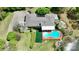Aerial view showcases pool, landscaped grounds and home's unique layout within a lush, verdant setting at 455 W Gleneagles Rd, Statesville, NC 28625