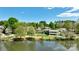Panoramic aerial view of the home, pool, and dock, nestled by the lake amidst vibrant greenery at 455 W Gleneagles Rd, Statesville, NC 28625