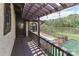 Balcony view of a well-maintained yard with a brick-surrounded pool and serene lake backdrop at 455 W Gleneagles Rd, Statesville, NC 28625