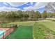 Expansive backyard with mature trees, green lawn, and direct water access offers outdoor activities and relaxation at 455 W Gleneagles Rd, Statesville, NC 28625