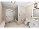 Functional bathroom with a shower/tub combo, white vanity, toilet, and unique paneled door at 455 W Gleneagles Rd, Statesville, NC 28625