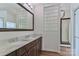 Bathroom with double sink vanity, framed mirror, and decorative glass block window at 455 W Gleneagles Rd, Statesville, NC 28625