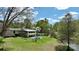 Elegant home with a swimming pool, arched windows, and beautiful landscaping set on a lush green lawn at 455 W Gleneagles Rd, Statesville, NC 28625