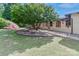 Landscaped yard with a mature tree and an inviting patio area, complemented by the home's architecture at 455 W Gleneagles Rd, Statesville, NC 28625