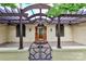 Charming covered front porch with wood beam pergola and a secure decorative metal gate at front at 455 W Gleneagles Rd, Statesville, NC 28625